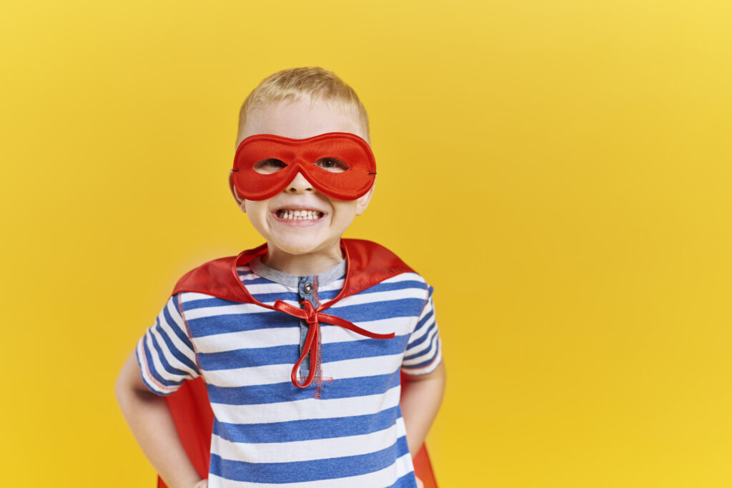 Portrait of boy in superhero costume in studio shot